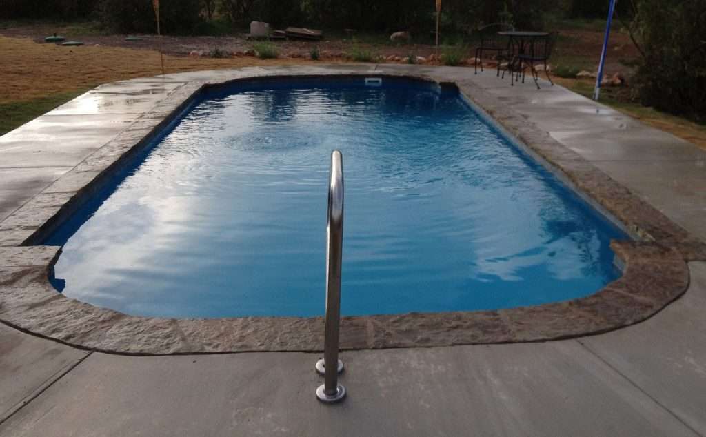 Phoenix model fiberglass pool San Antonio manufactured for a lifetime of swimming fun by Lonestar Pools your private Backyard Oasis staycation station The Phoenix medium-sized fiberglass in-ground pool measures 30’ x 14′